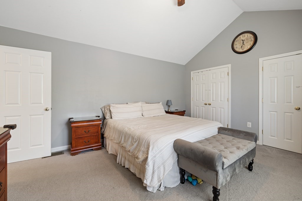 9 Evergreen Road Salem, NH 03079 - Photo 17 of 41 a bedroom with a bed and a chandelier