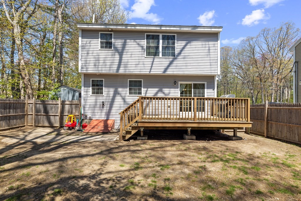 9 Evergreen Road Salem, NH 03079 - Photo 39 of 41 a view of a house with a wooden deck and a yard