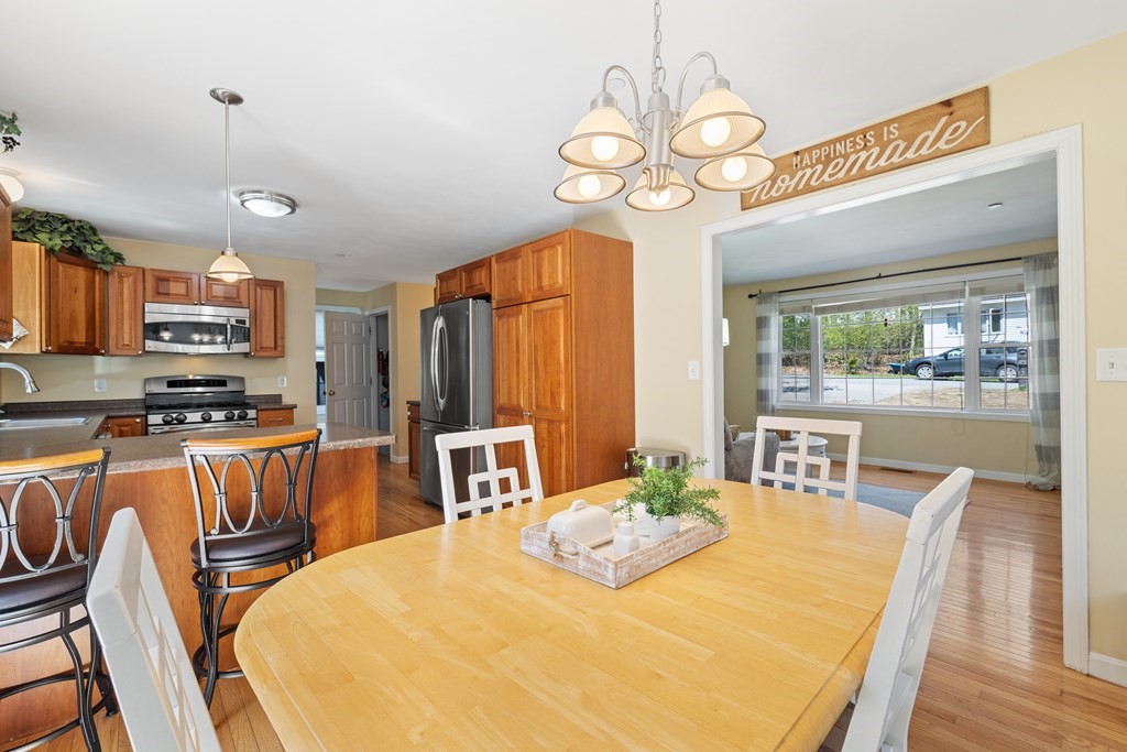 9 Evergreen Road Salem, NH 03079 - Photo 6 of 41 a view of a dining room with furniture large window and wooden floor