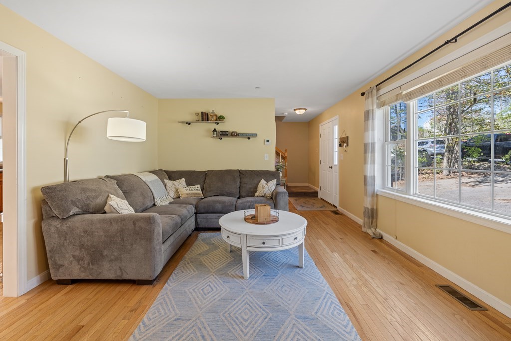 9 Evergreen Road Salem, NH 03079 - Photo 10 of 41 a living room with a couch and a large window
