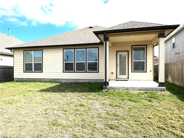 a view of a house with a small yard and wooden floor