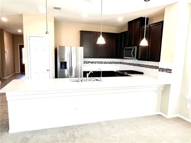a view of a living room and kitchen