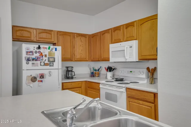 a kitchen with stainless steel appliances a stove a refrigerator and cabinets