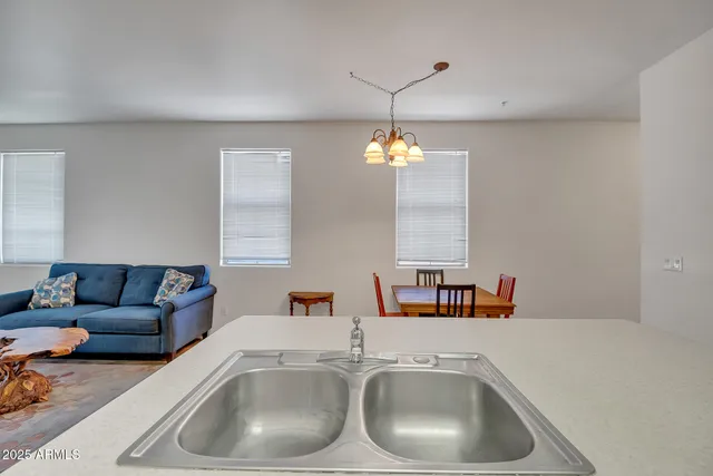 a kitchen with a sink and a stove top oven with wooden floor