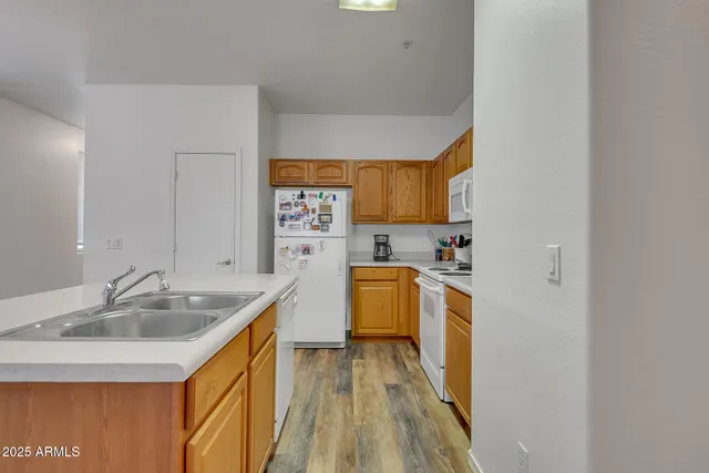 a kitchen with a sink stove and refrigerator