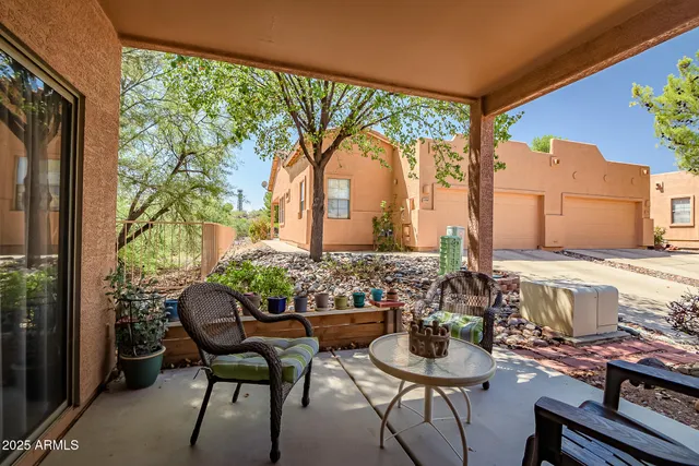 a view of a patio with table and chairs and potted plants
