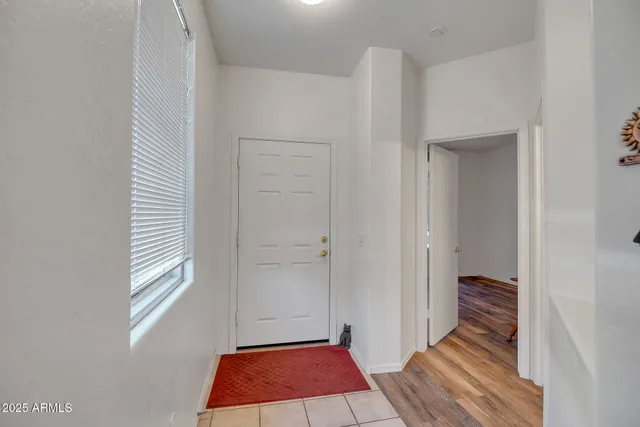 a room with a rug and a window