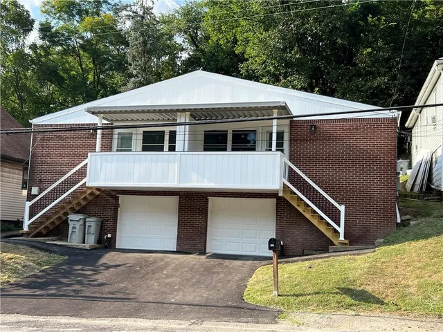 a front view of a house with a garage