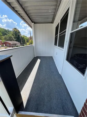 a room with a bed and hardwood floor