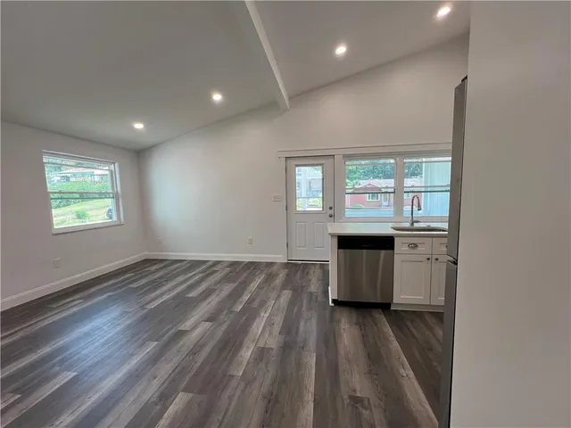 a view of a hallway with a hardwood