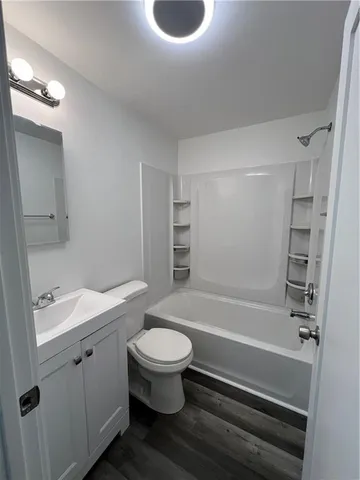 a view of a room with wooden floor