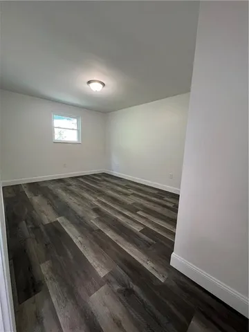 a view of hallway with wooden floor