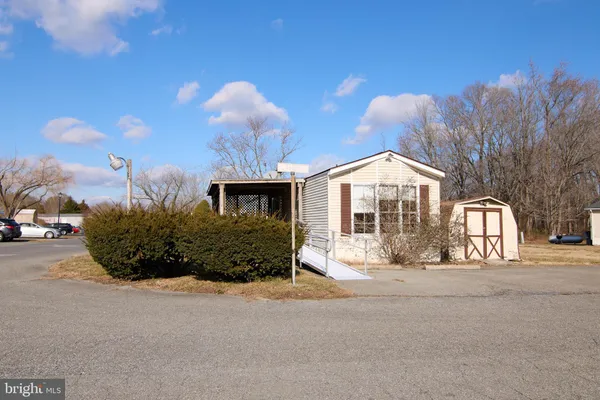 a view of a house with a yard and pathway
