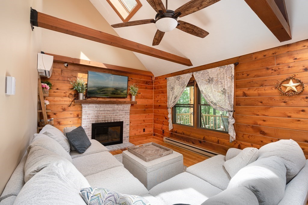 769 Mason Road Holden, MA 01522 - Photo 11 of 29 a living room with furniture a fireplace and a flat screen tv
