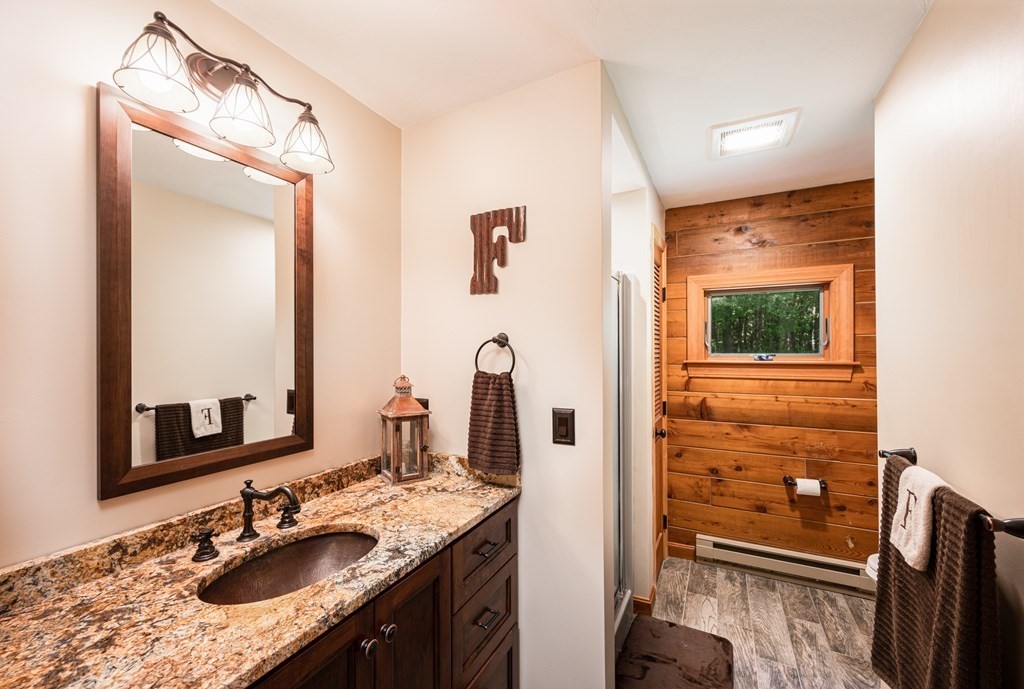 769 Mason Road Holden, MA 01522 - Photo 16 of 29 a bathroom with a granite countertop sink a mirror and shower