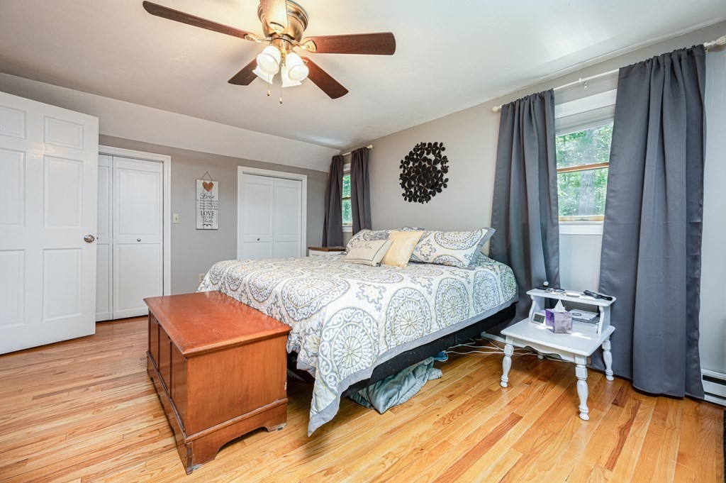 769 Mason Road Holden, MA 01522 - Photo 17 of 29 a bedroom with a bed and a chandelier