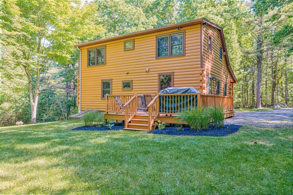 769 Mason Road Holden, MA 01522 - Photo 25 of 29 a front view of a house with a yard table and chairs