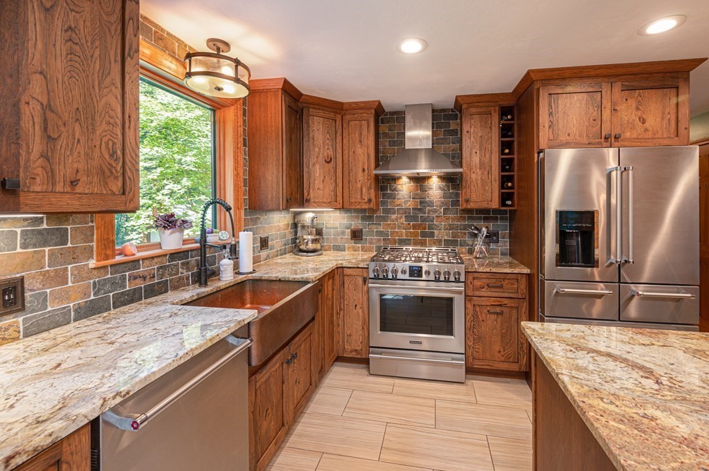 769 Mason Road Holden, MA 01522 - Photo 5 of 29 a kitchen with stainless steel appliances granite countertop a sink stove refrigerator and cabinets