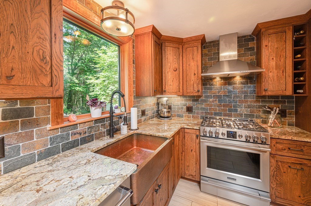769 Mason Road Holden, MA 01522 - Photo 6 of 29 a kitchen with stainless steel appliances granite countertop a stove a sink and a microwave