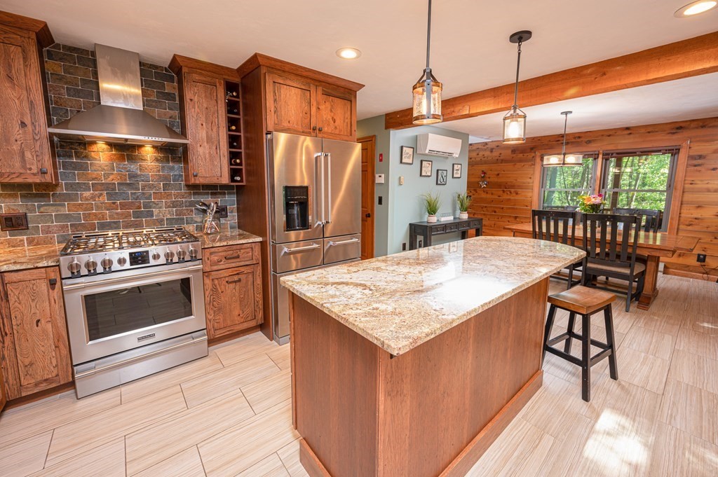 769 Mason Road Holden, MA 01522 - Photo 7 of 29 a kitchen with a stove a sink cabinetry and a kitchen island