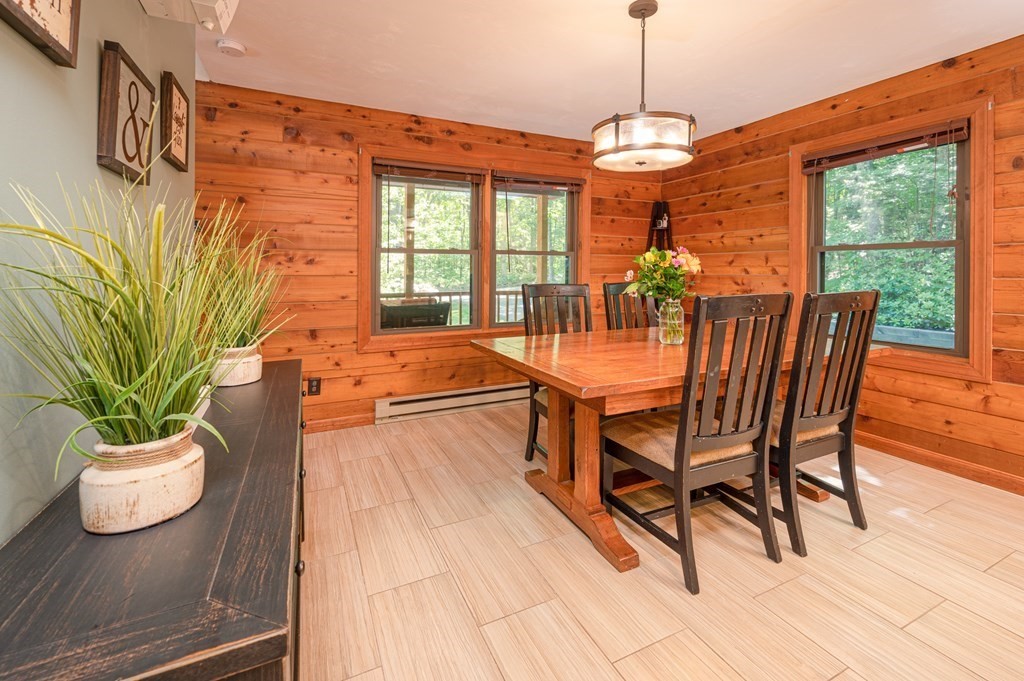 769 Mason Road Holden, MA 01522 - Photo 9 of 29 a dining room with furniture potted plants and wooden floor