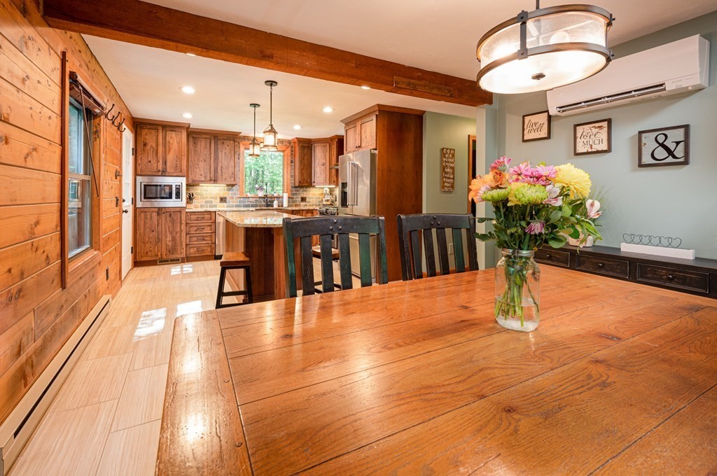 769 Mason Road Holden, MA 01522 - Photo 10 of 29 a dining hall with stainless steel appliances kitchen island granite countertop a dining table chairs and view of living room