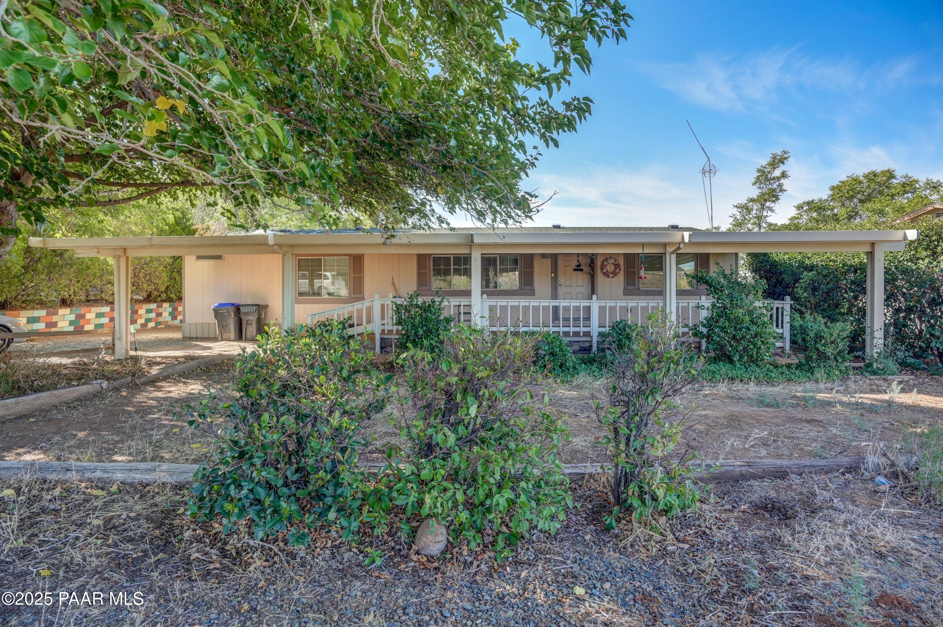 a front view of house with yard and trees around