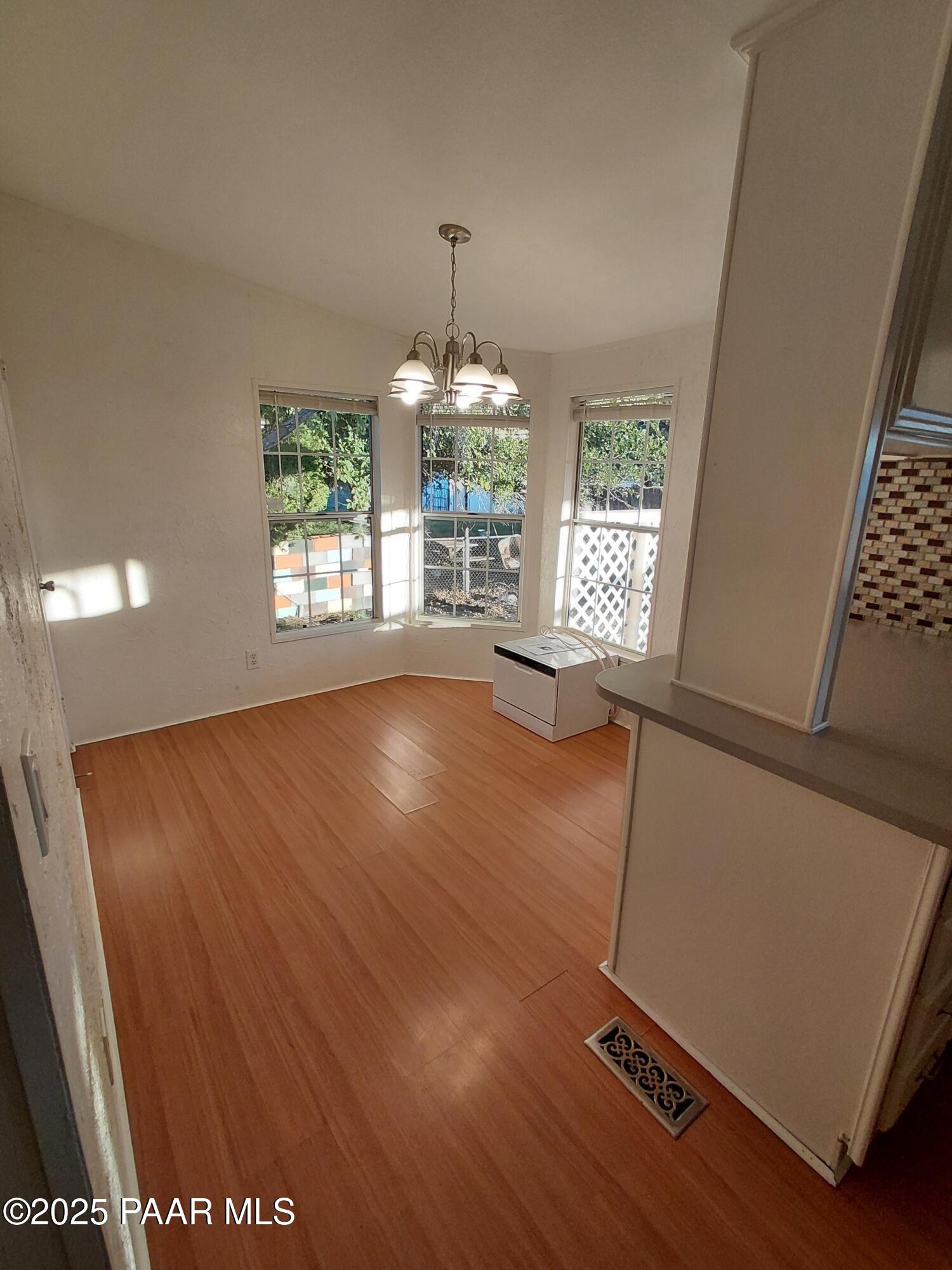 17351 East Bob White Road Mayer, AZ 86333 - Photo 23 of 54 wooden floor in an empty room with a window