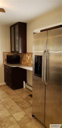 631 Magnolia Road North Brunswick, NJ 08902 - Photo 11 of 20 a kitchen with a refrigerator and a sink