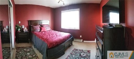 631 Magnolia Road North Brunswick, NJ 08902 - Photo 13 of 20 a bedroom with a bed and a lamp on dresser