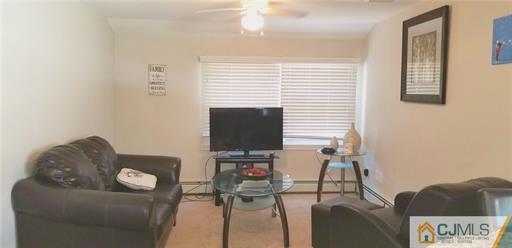 631 Magnolia Road North Brunswick, NJ 08902 - Photo 14 of 20 a living room with furniture and a flat screen tv