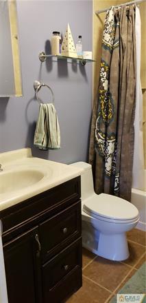 631 Magnolia Road North Brunswick, NJ 08902 - Photo 16 of 20 a bathroom with a sink a toilet and shower curtain