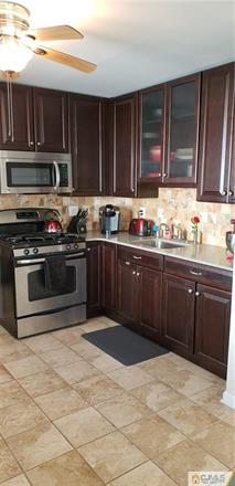 631 Magnolia Road North Brunswick, NJ 08902 - Photo 6 of 20 a kitchen with a sink stove top oven and cabinets
