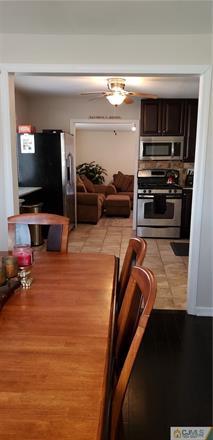 631 Magnolia Road North Brunswick, NJ 08902 - Photo 7 of 20 a living room with furniture and a flat screen tv