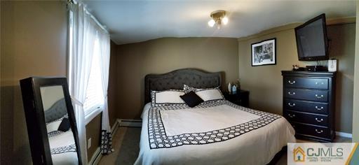 631 Magnolia Road North Brunswick, NJ 08902 - Photo 8 of 20 a bedroom with a bed and a flat screen tv