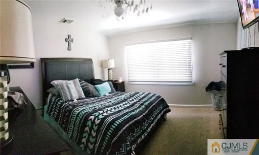 631 Magnolia Road North Brunswick, NJ 08902 - Photo 10 of 20 a bed sitting in a bedroom next to a window