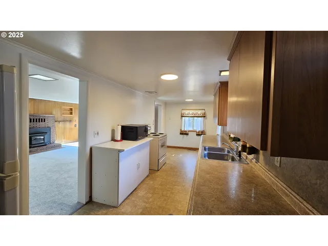 a kitchen with stainless steel appliances a sink stove and cabinets