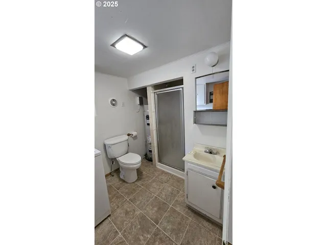 a kitchen with a refrigerator and cabinets