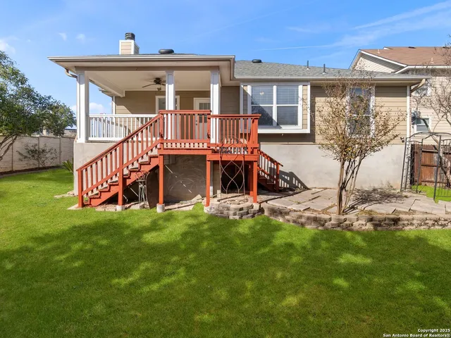 a view of a house with a yard and deck