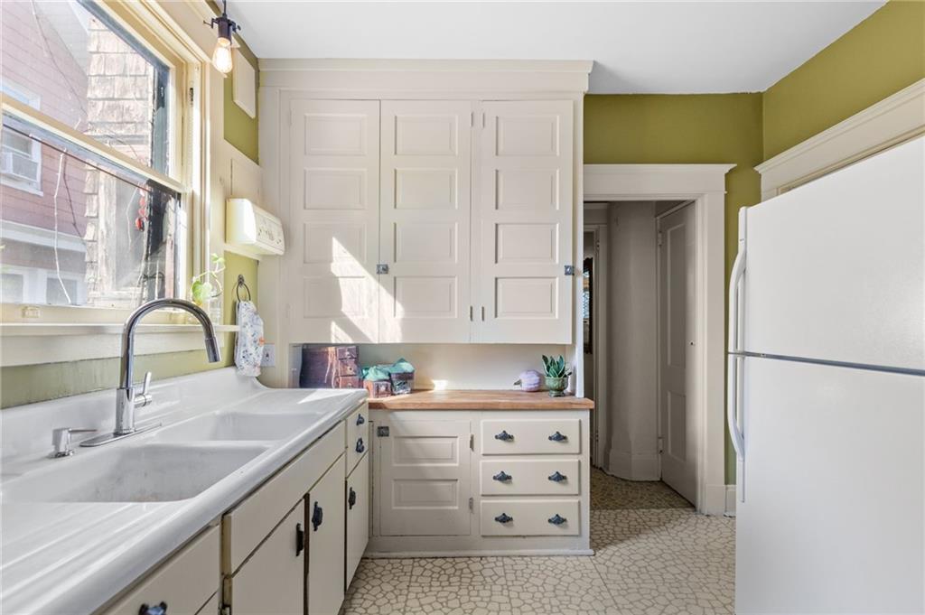 1139 Davis Avenue Pittsburgh, PA 15212 - Photo 15 of 35 a kitchen with appliances a sink and cabinets