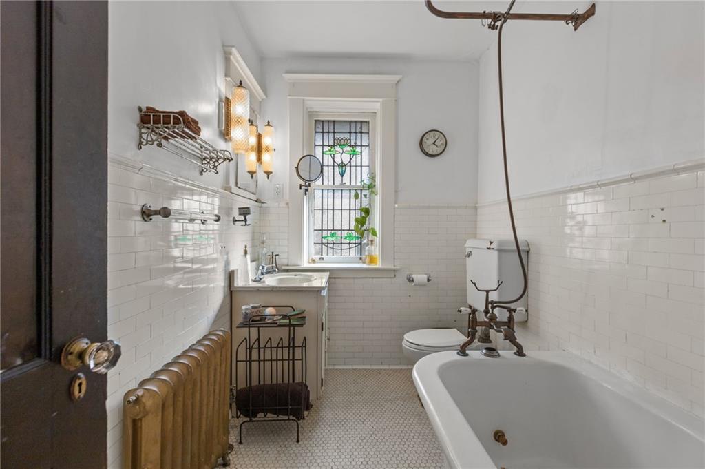 1139 Davis Avenue Pittsburgh, PA 15212 - Photo 18 of 35 a bathroom with a tub sink and mirror
