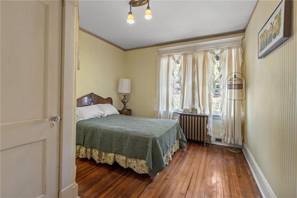 1139 Davis Avenue Pittsburgh, PA 15212 - Photo 25 of 35 a bedroom with a bed and wooden floor
