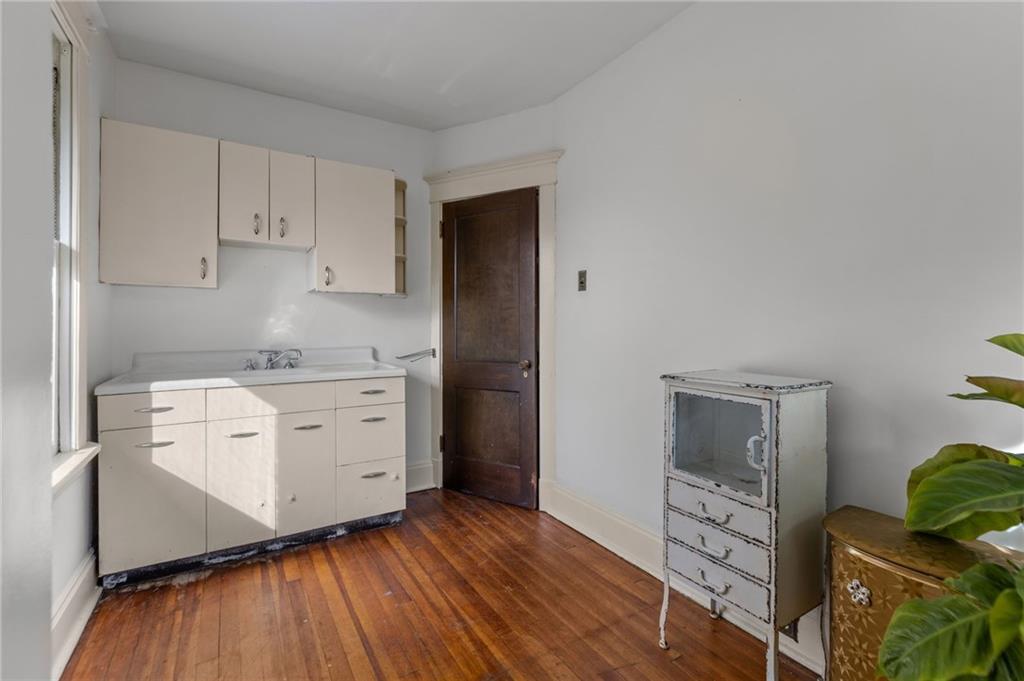 1139 Davis Avenue Pittsburgh, PA 15212 - Photo 26 of 35 a room with white cabinets and wooden floors