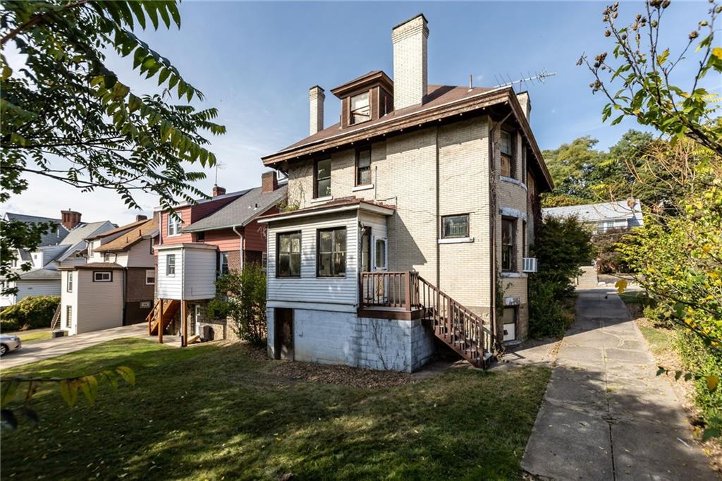 1139 Davis Avenue Pittsburgh, PA 15212 - Photo 34 of 35 a front view of a house with a yard