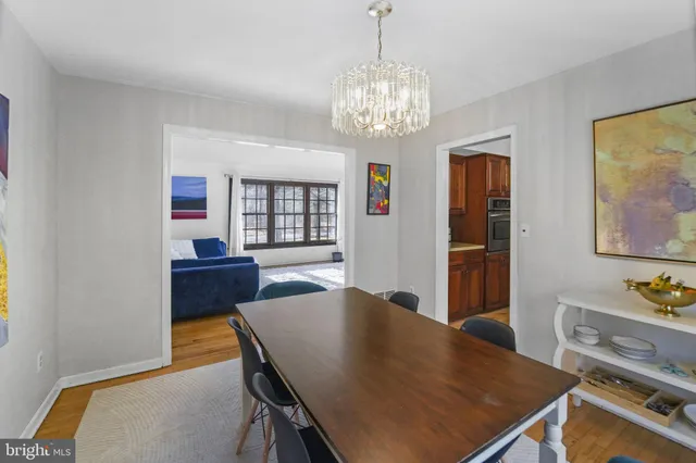 a view of a dining room with furniture and chandelier