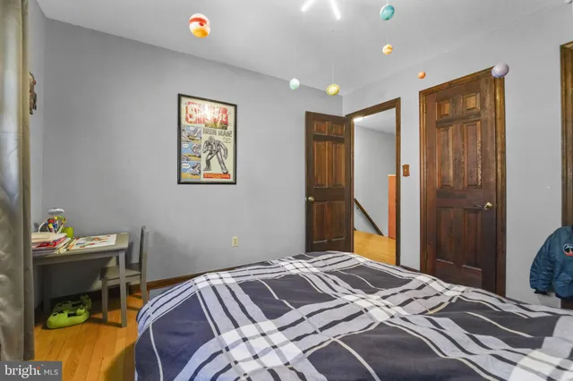 a bedroom with a bed and a desk