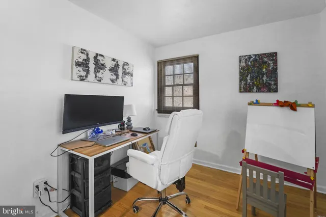 a view of a workspace with furniture and a flat screen tv