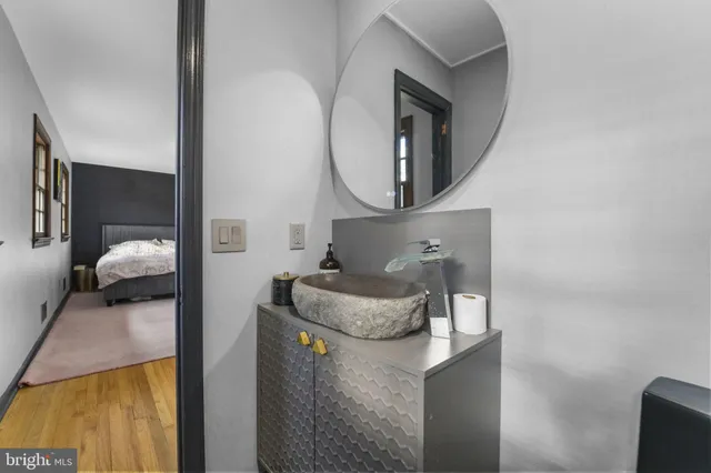 a living room with furniture and a mirror