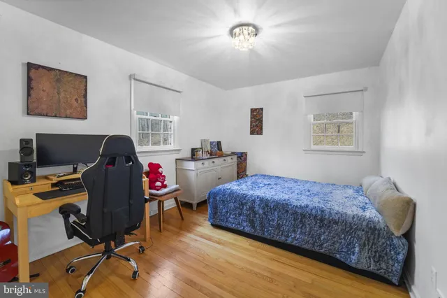 a bedroom with a bed window and a chandelier