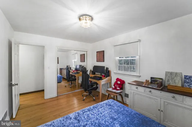 a view of a livingroom with workspace and a window